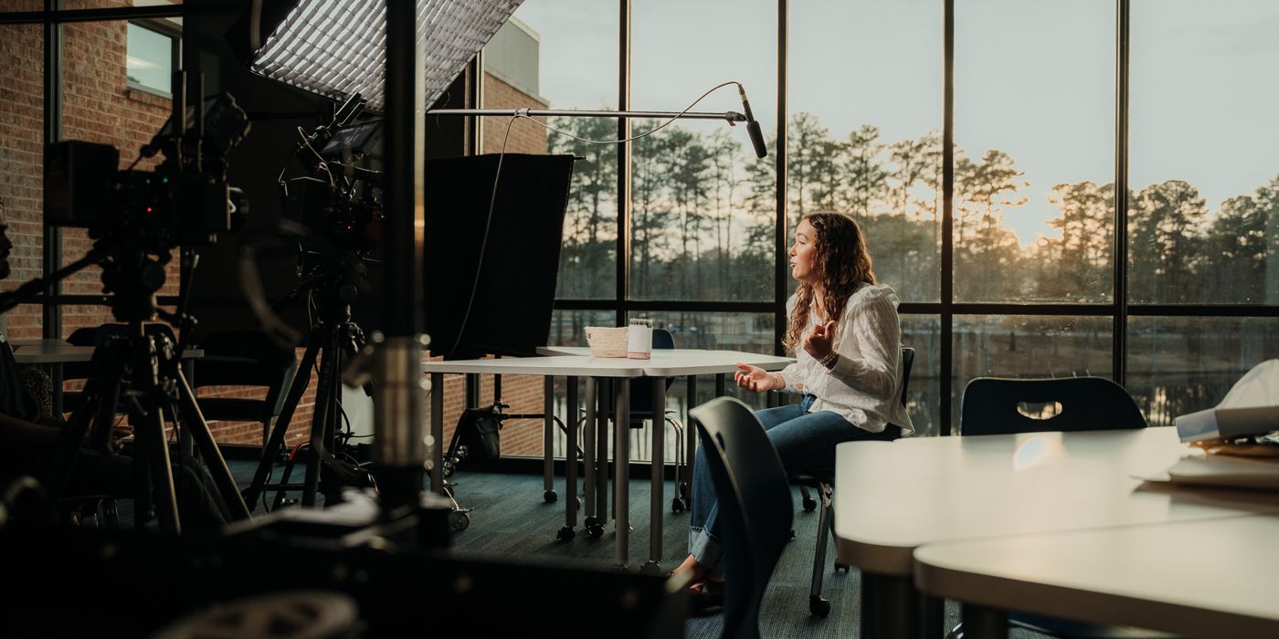 Lights and cameras framing a lakeside interview
