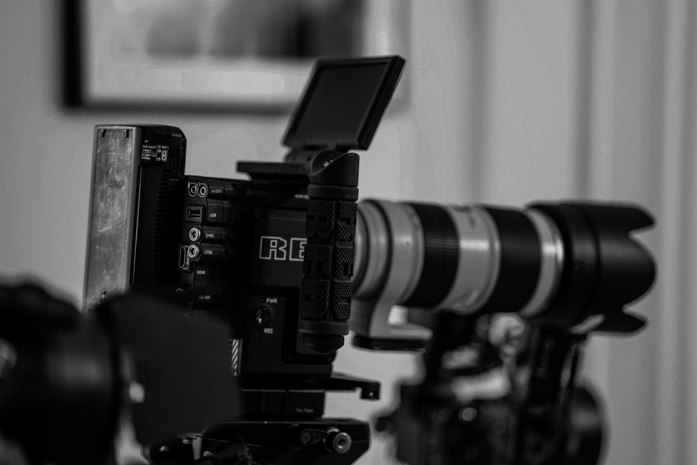 A cinema camera on set, in black and white