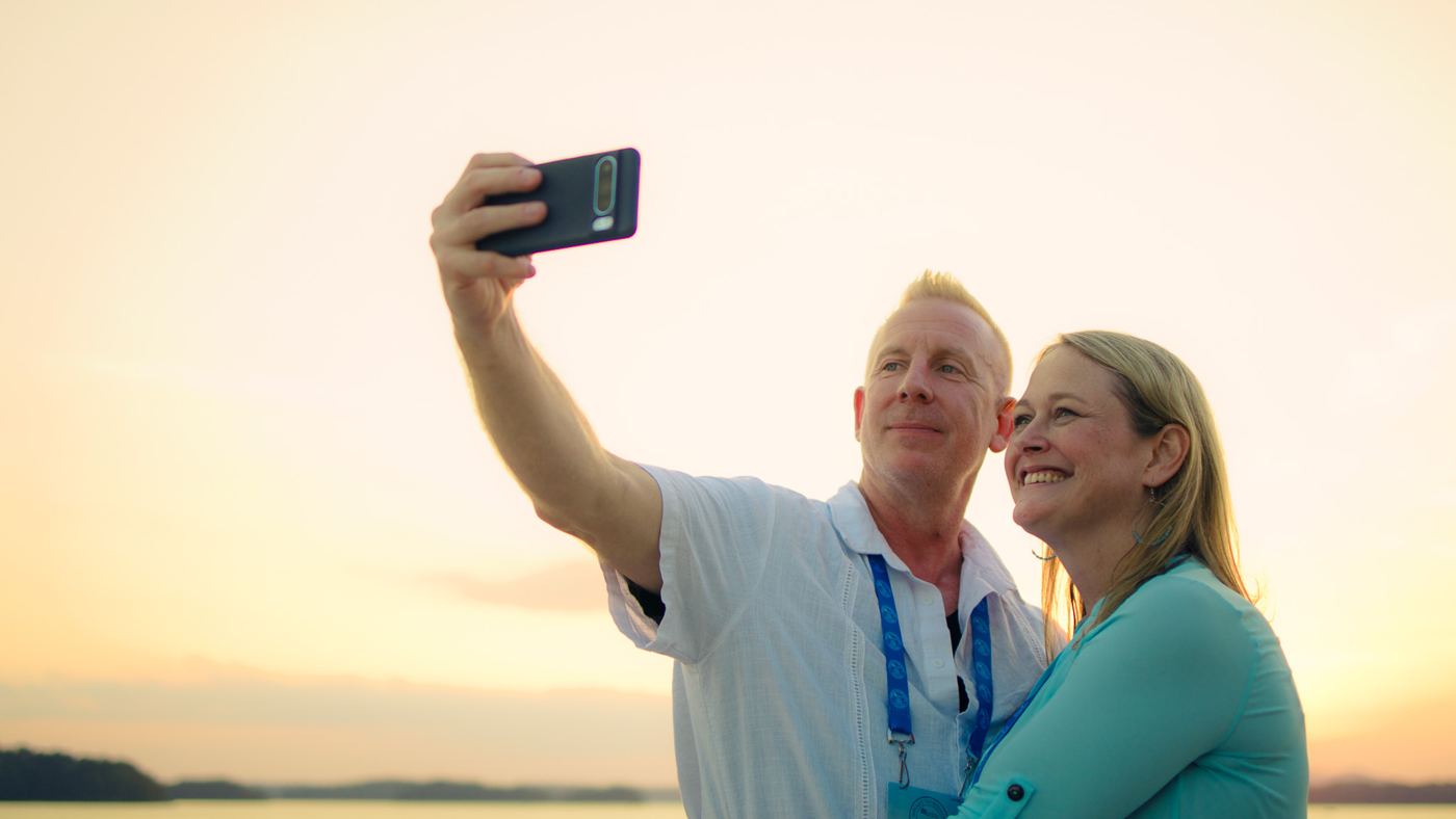 A couple taking a selfie at sunset, from a brand film