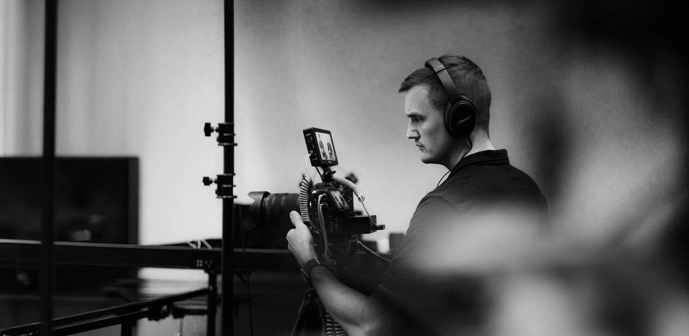 A camera operator at work, in black and white