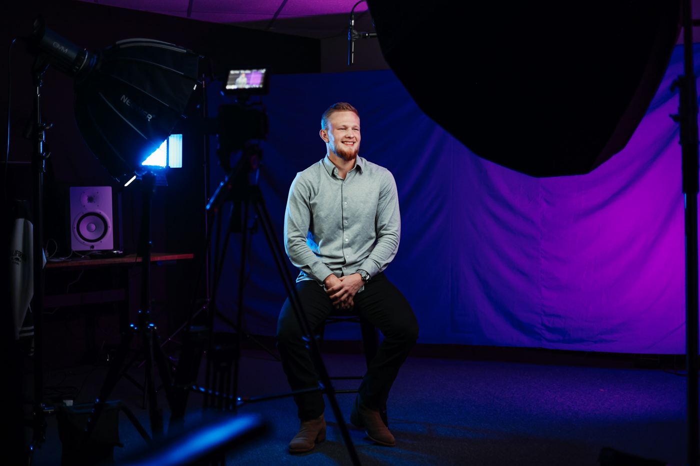 An interview subject on a purple studio set